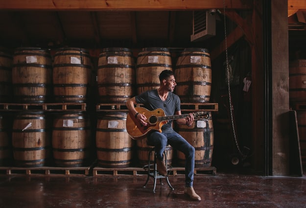 Pime Hernandez playing guitar at Leiper's Fork Distillery